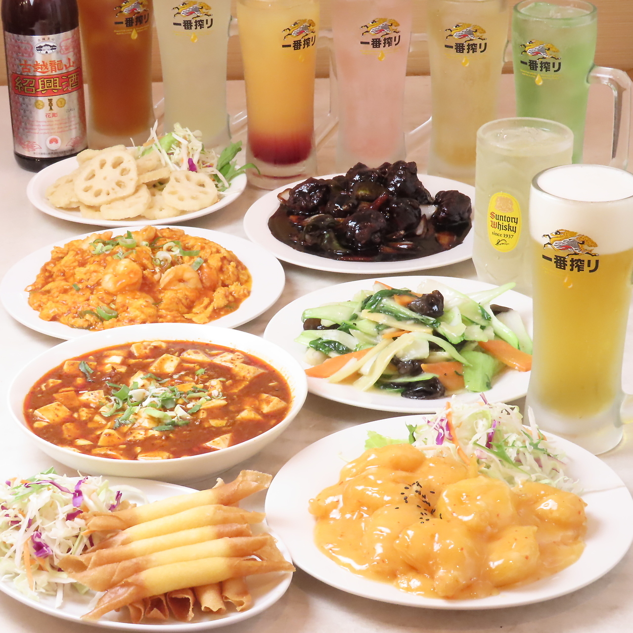 コース料理の皿と各種ドリンクが並ぶ写真