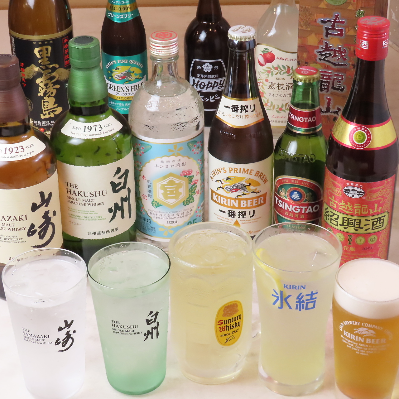 各種ドリンクのボトルとグラスが並ぶ写真